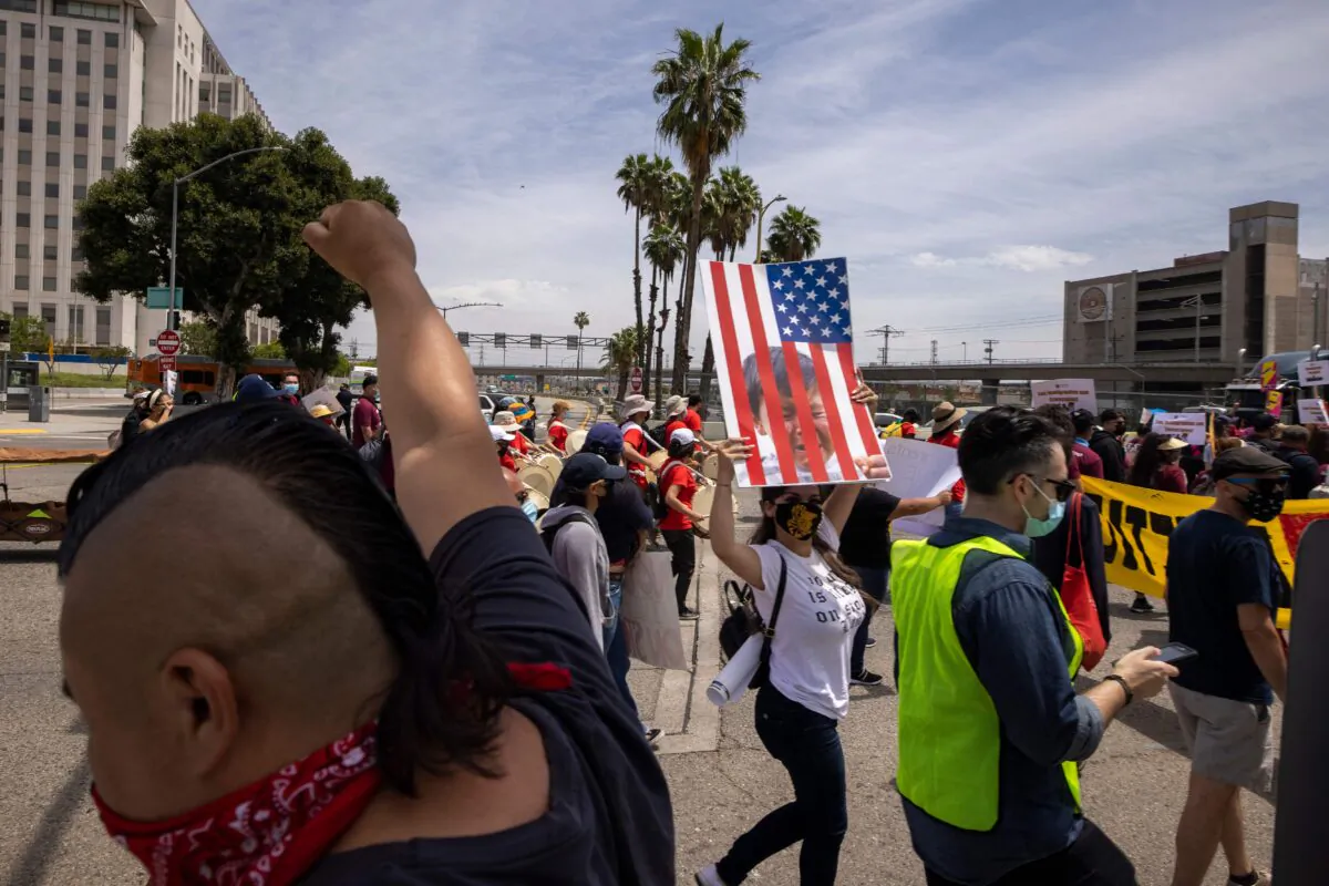 A coalition of activist groups and labor unions participate in a May Day march for workers' and human rights in Los Angeles, Calif., on May 1, 2021. (David McNew/AFP via Getty Images)