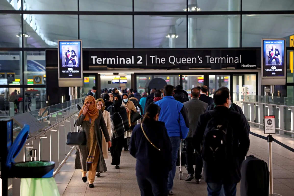 People queue to enter terminal 2, at Heathrow Airport, London, on Jan. 18, 2021. (Henry Nicholls/Reuters)