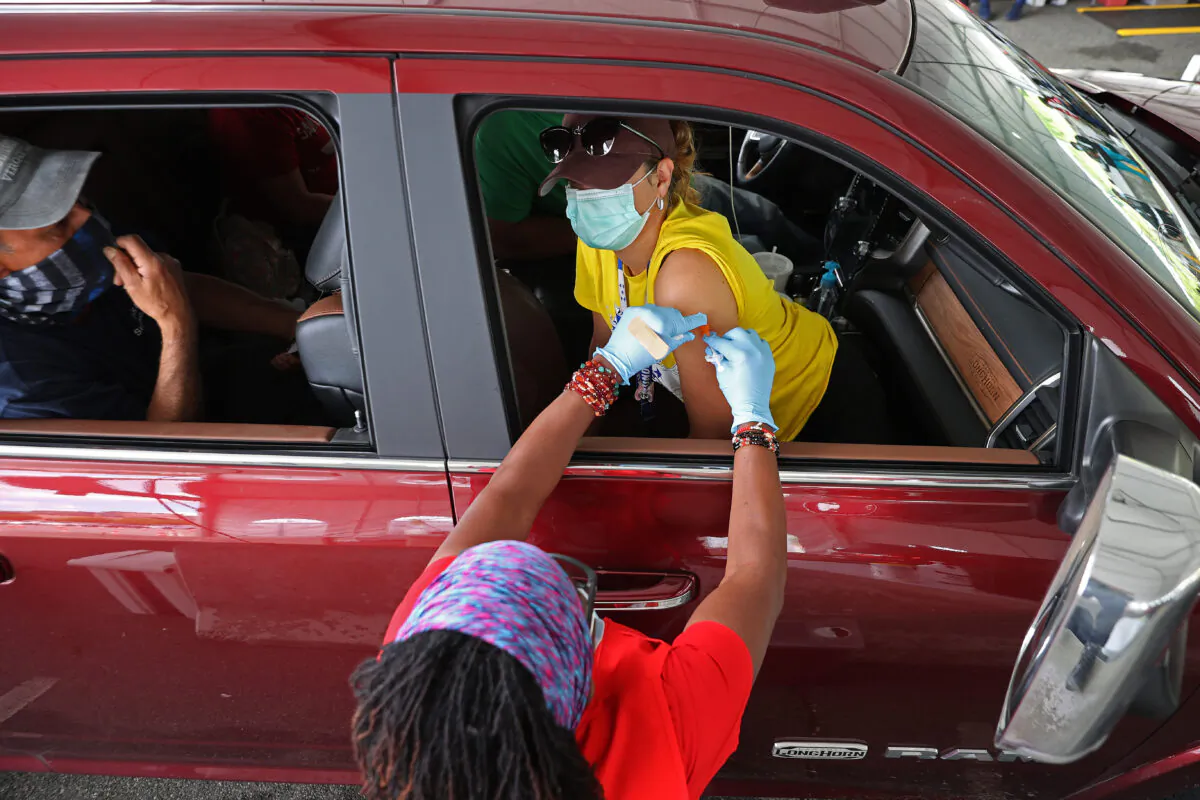 A woman receives her first dose of the Pfizer COVID-19 vaccine at the mass vaccination site at Ripken Basebal in Aberdeen, Md., on May 5, 2021. (Chip Somodevilla/Getty Images)