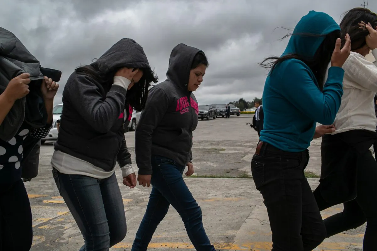 Women walk from the airport tarmac after being deported from the United States, in Guatemala City, Guatemala, on May 30, 2019. (John Moore/Getty Images)