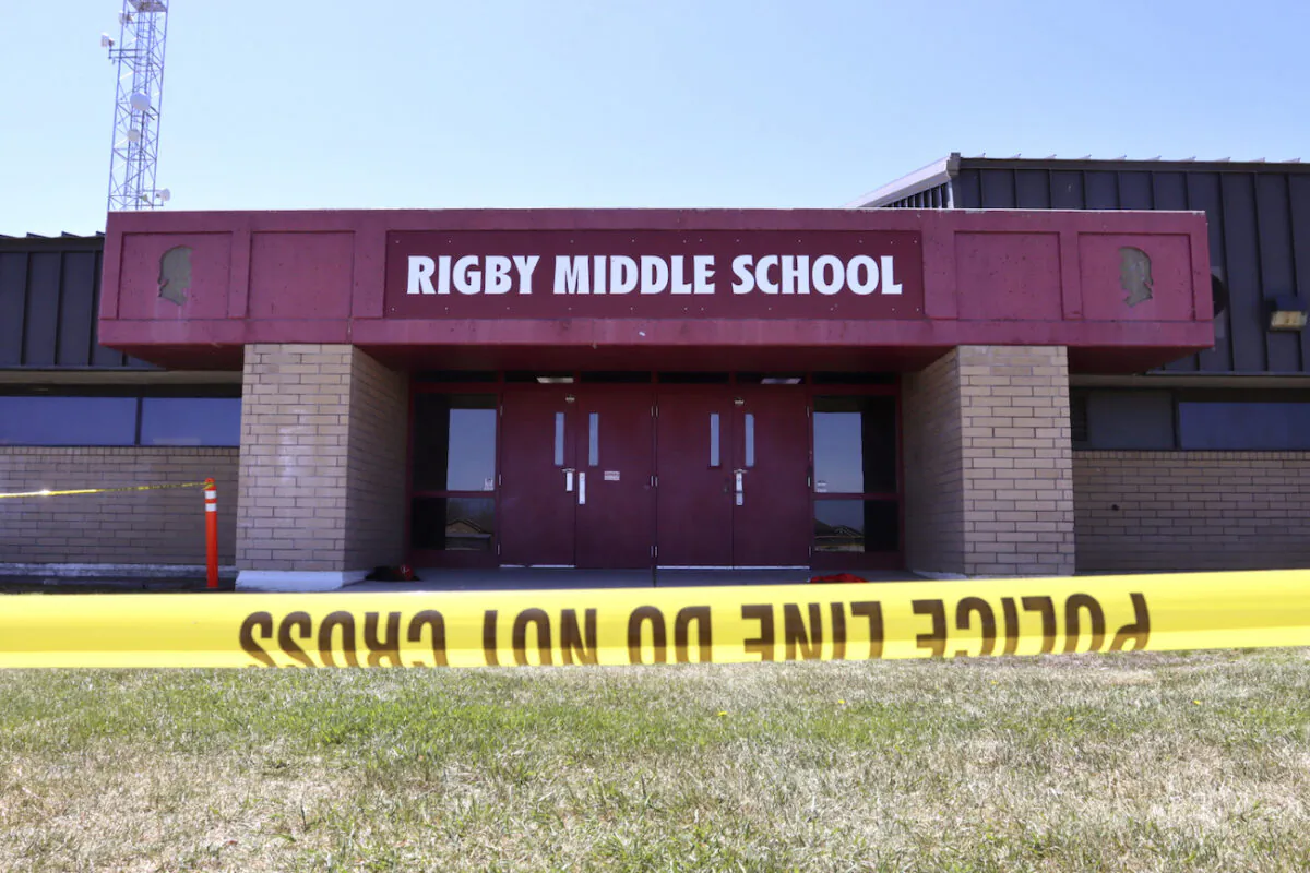 Police tape marks a line outside Rigby Middle School following a shooting there, in Rigby, Idaho, on May 6, 2021. (AP Photo/Natalie Behring)