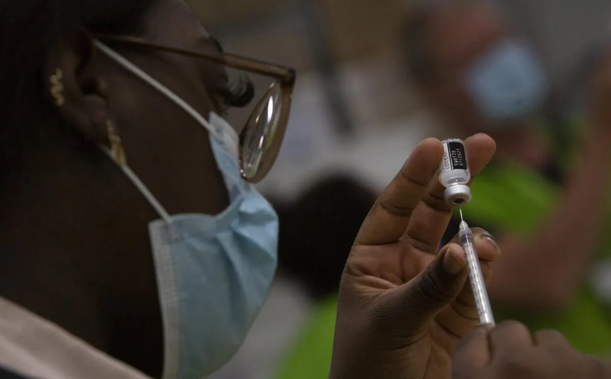 A pharmacist fills a syringe with a vial of the Pfizer COVID-19 vaccine at the Vaccine Village in Antwerp, Belgium on April 30, 2021. (Virginia Mayo/AP Photo)