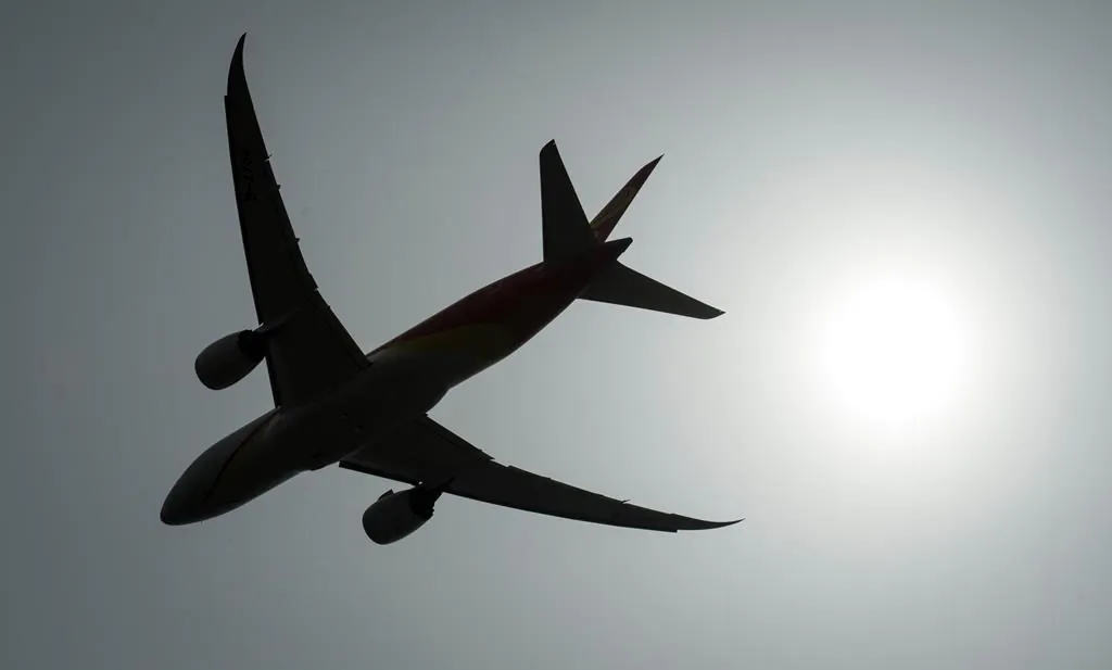 A plane is silhouetted as it takes off from Vancouver International Airport in Richmond, B.C., on May 13, 2019. (The Canadian Press/Jonathan Hayward)