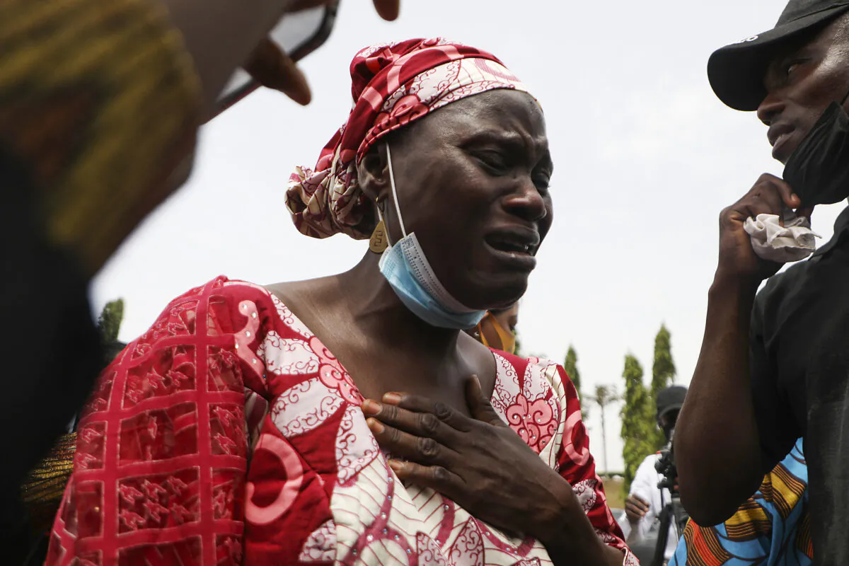 Rabi Magaji-Zakariah (C), a mother of one of the Federal College of Forestry Mechanization students who has been abducted, cries during a demonstration in Abuja to demand the release of their families who have spent 55 days in captivity, in Nigeria on May 4, 2021. (Kola Sulaimon/AFP via Getty Images)