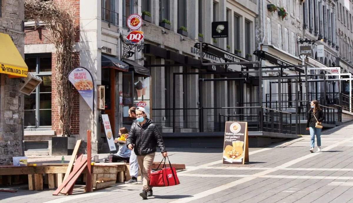 People walk past empty patios in Jacques Cartier Square in Montreal on May 7, 2021. (The Canadian Press/Ryan Remiorz)