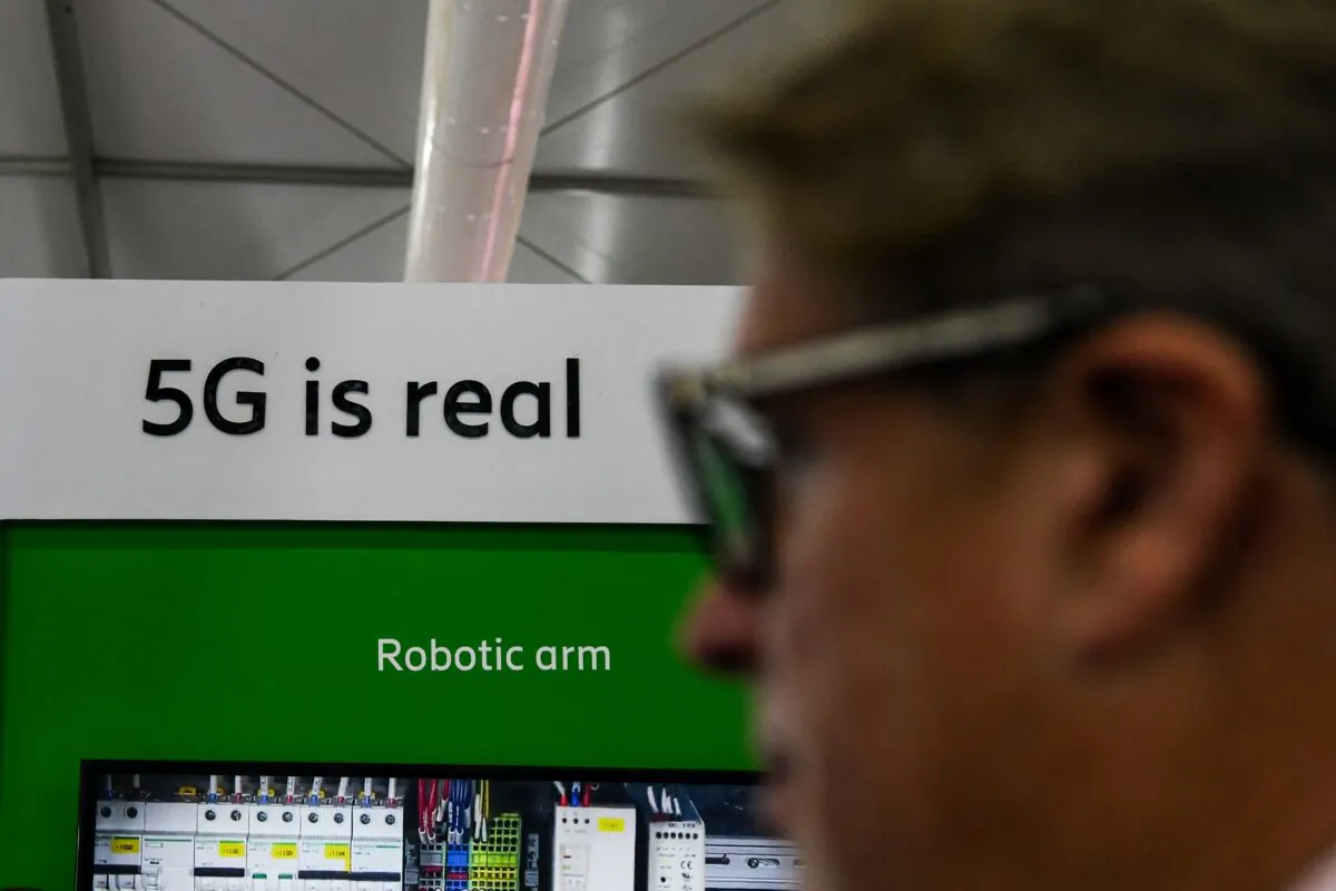 A visitor walks past a 5G display at the India Mobile Congress 2018 in New Delhi on Oct. 25, 2018. (CHANDAN KHANNA/AFP via Getty Images)