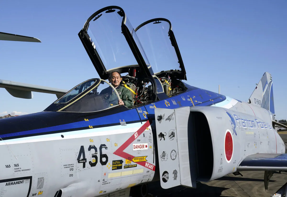 Japanese Prime Prime Minister Yoshihide Suga sits in the cockpit of a F4EJ Kai jet fighter of Japan's Air Self-Defense Force after reviewing the force's personnel at Iruma Air Base in Sayama, Saitama Prefecture, on Nov. 28, 2020. (Kimimasa Mayama/Pool/AFP via Getty Images)