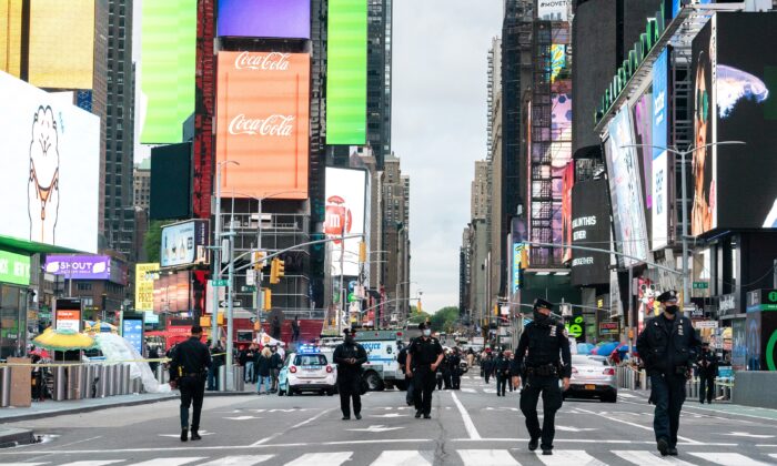 New York City police officers stand guard after a shooting incident in Times Square, New York City, on May 8, 2021. (Jeenah Moon/Reuters)