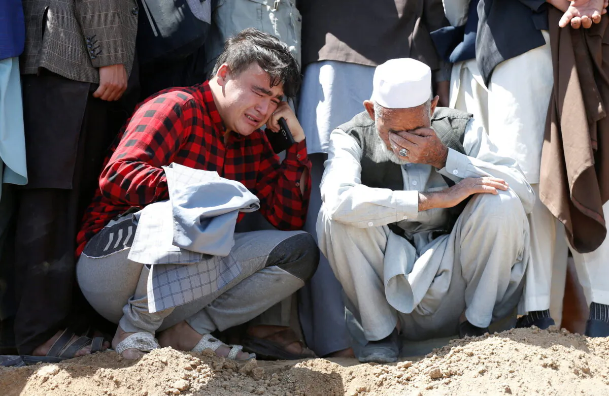 Relatives mourn the victims of May 8's explosion during a mass funeral ceremony in Kabul, Afghanistan, on May 9, 2021. (Stringer/Reuters)