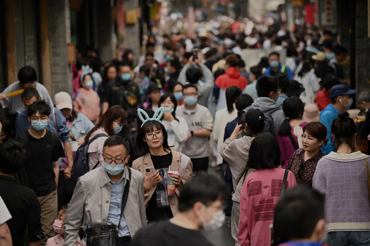 People walk through an alley near Houhai lake in Beijing, China, on May 4, 2021. (Noel Celis/AFP via Getty Images)