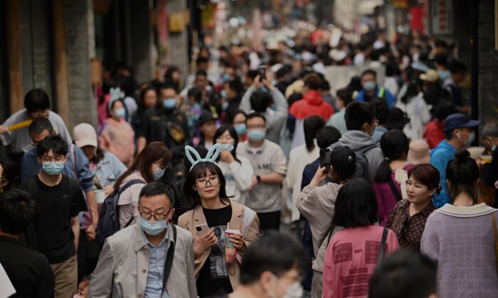 People walk through an alley near Houhai lake in Beijing, China, on May 4, 2021. (Noel Celis/AFP via Getty Images)