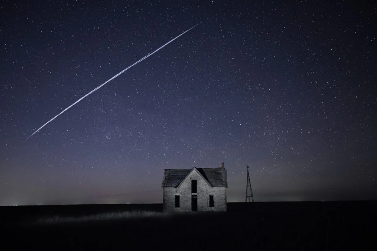A string of SpaceX StarLink satellites passes over an old stone house near Florence, Kan., on May 6, 2021. (Reed Hoffmann/AP Photo)