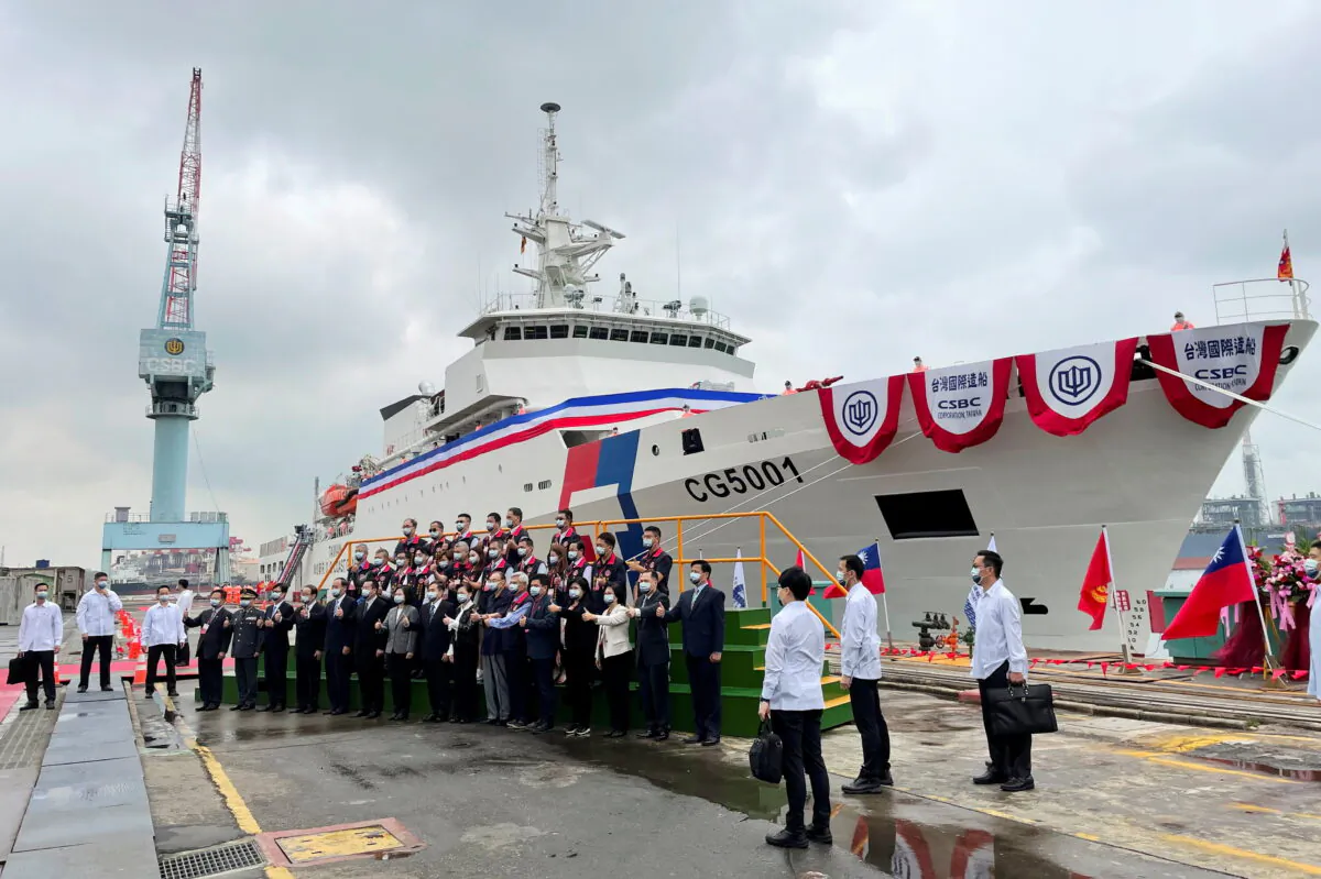Taiwan President Tsai Ing-wen and others pose for photos in front of the newly launched coast guard flagship Chiayi in Kaohsiung, Taiwan, on April 29, 2021. (Yimou Lee/Reuters)