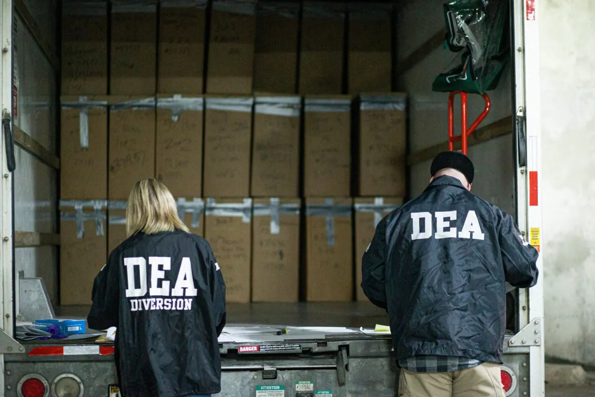 Prescriptions drugs collected during the Drug Enforcement Administration (DEA)s Take Back Day event are placed into plastic bags by members of the DEA in White Plains, N.Y., on April 24, 2021. (Kena Betancur/AFP via Getty Images)