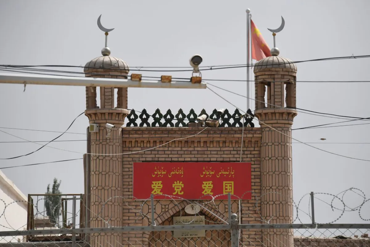 The Jieleixi No.13 village mosque with slogans “Love the [Chinese Communist] Party, Love China,” in Yangisar, south of Kashgar, in China's western Xinjiang region on June 4, 2019. (Greg Baker/AFP via Getty Images)