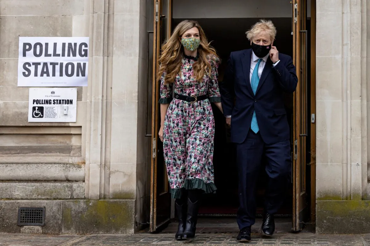 Prime Minister Boris Johnson and his fiancée Carrie Symonds leave Methodist Central Hall in Westminster, London, after voting on May 6, 2021. (Rob Pinney/Getty Images)