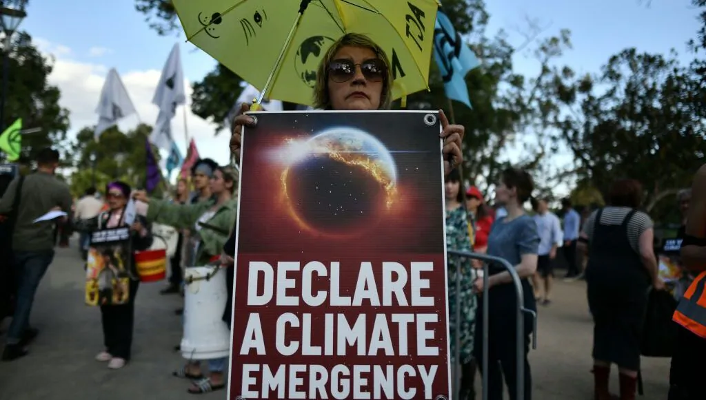 Demonstrators hold up placards outside the Australian Open venue during a climate protest rally in Melbourne, Australia on Jan. 24, 2020. (Manan Vatsyayana/AFP via Getty Images)