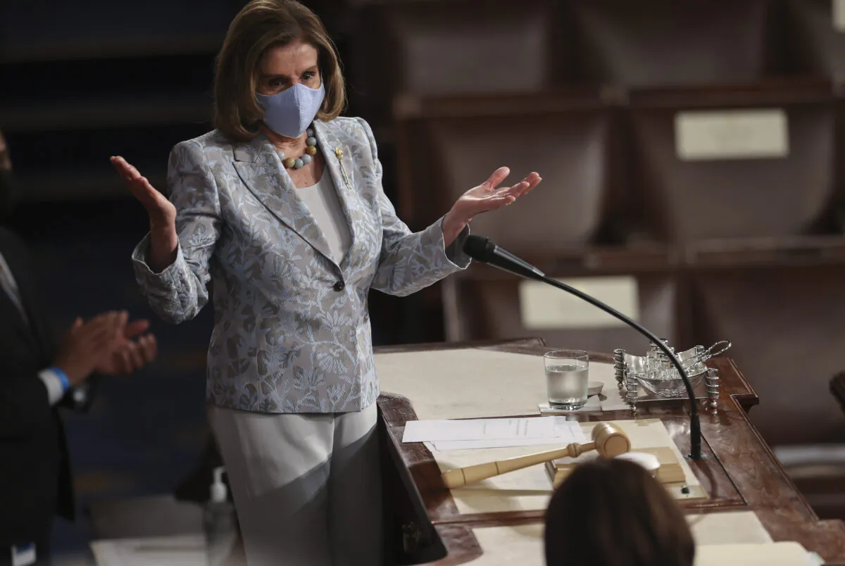 Speaker of the House Nancy Pelosi greets U.S. Vice President Kamala Harris (foreground) as she arrives on the podium to attend President Joe Biden as he addresses a joint session of Congress in the House chamber of the U.S. Capitol in Washington, on April 28, 2021. (Jonathan Ernst-Pool/Getty Images)