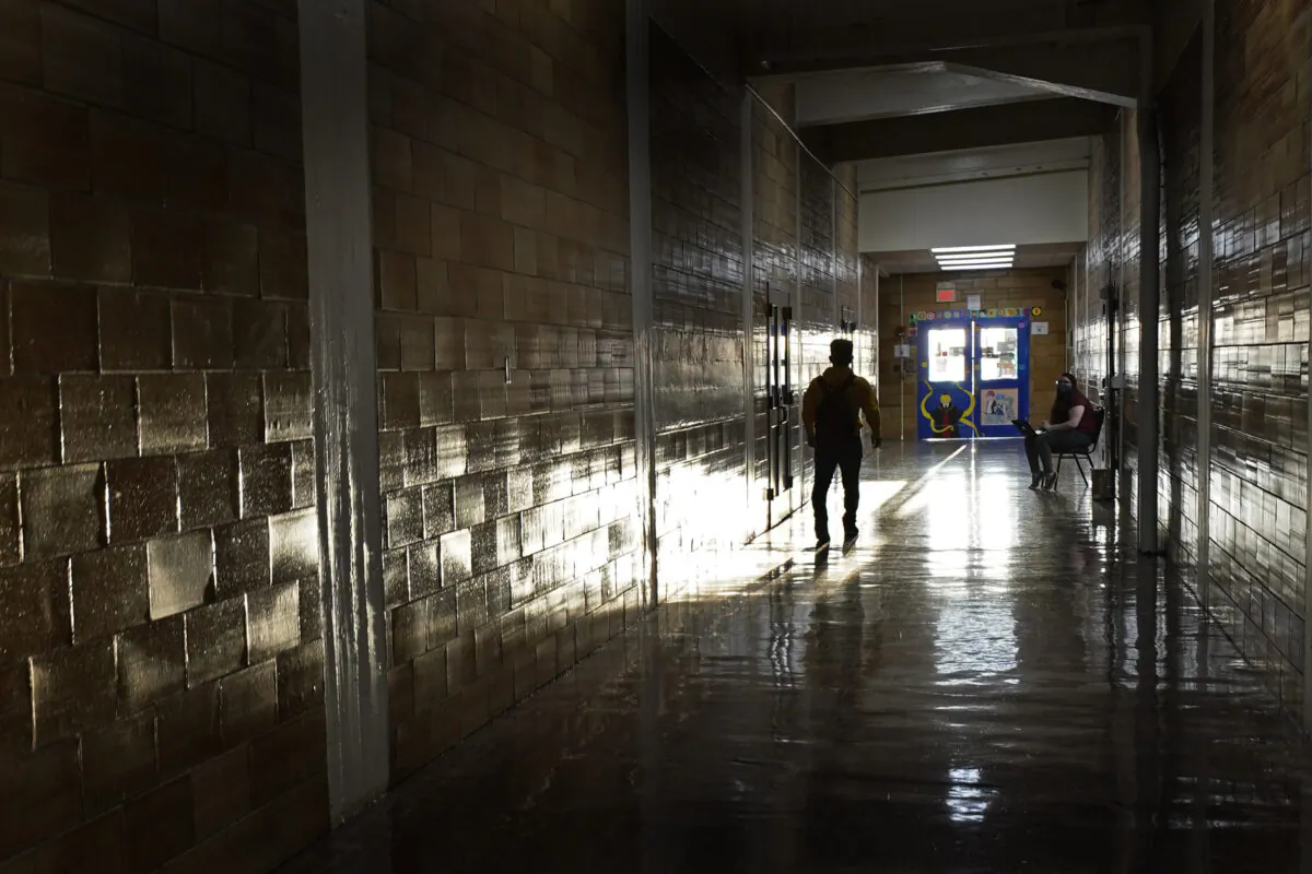 A student walks between classes at Wyandotte High School in Kansas City, Kan., on the first day of in-person learning, on March 30, 2021. (Charlie Riedel/AP Photo)
