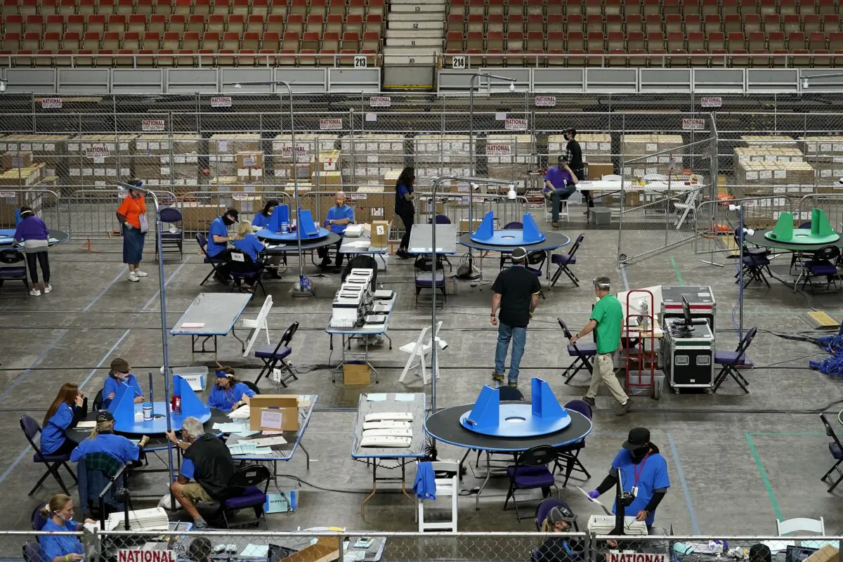 Maricopa County ballots cast in the 2020 general election are examined and recounted by contractors working for Florida-based company, Cyber Ninjas, at Veterans Memorial Coliseum in Phoenix, Ariz., on May 6, 2021. (Matt York/AP Photo)