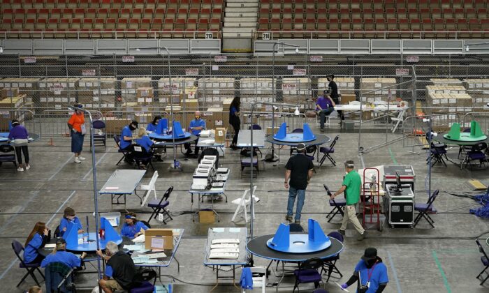 Maricopa County ballots cast in the 2020 general election are examined and recounted by contractors working for Florida-based company, Cyber Ninjas, at Veterans Memorial Coliseum in Phoenix, Ariz., on May 6, 2021. (Matt York/AP Photo)