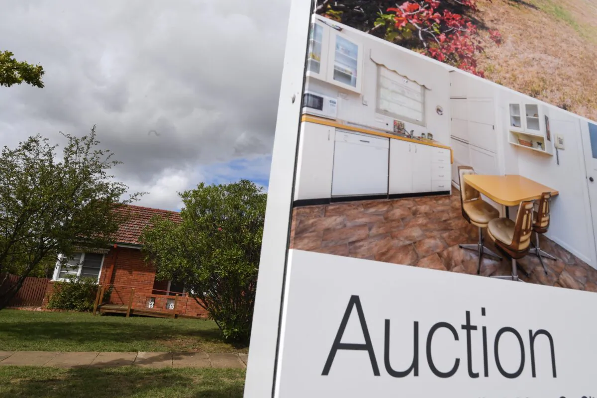 A real estate advertising board is seen in Canberra, Australia, April 4, 2017. (AAP Image/Lukas Coch)