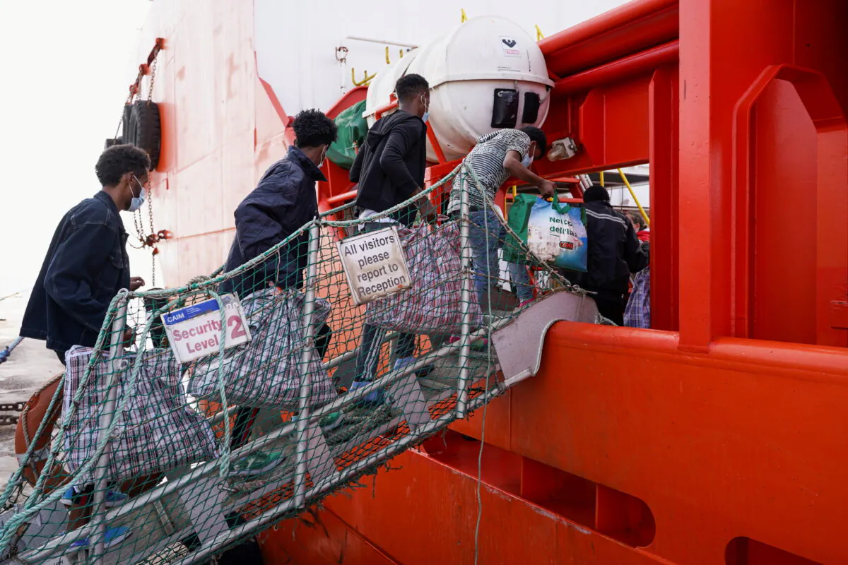 Illegal immigrants from the reception center board the Asso Trenta ship to be taken to the quarantine ship GNV Azzurra, in Lampedusa, Italy, on May 11, 2021. (Antonio Parrinello/Reuters)
