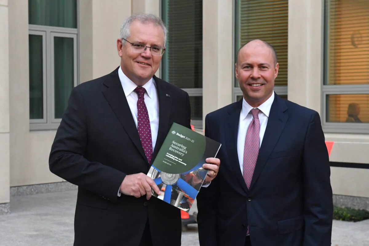 Prime Minister Scott Morrison and Treasurer Josh Frydenberg conducting interviews after Frydenberg delivered the 2021-22 Budget in the House of Representatives at Parliament House in Canberra, Australia on May 12, 2021. (AAP Image/Mick Tsikas) 