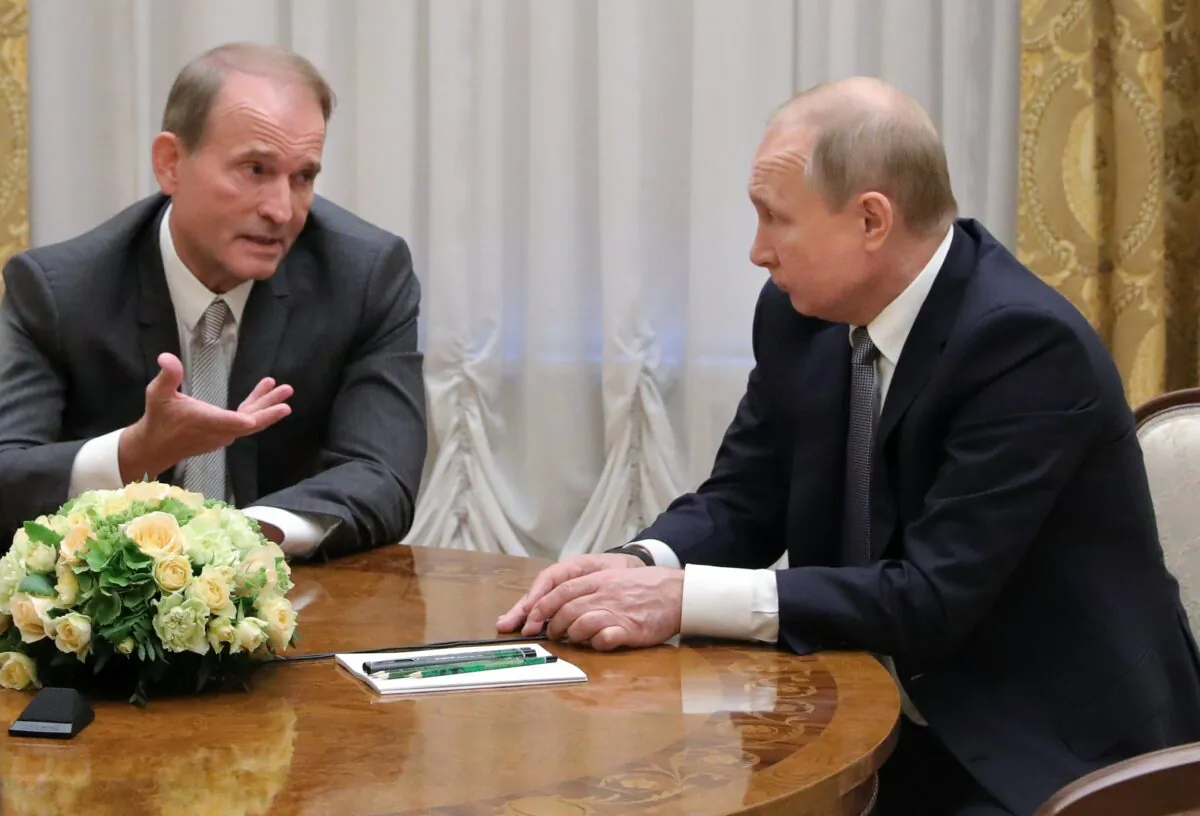 Russian President Vladimir Putin's closest associates, Ukrainian tycoon Viktor Medvedchuk, left, speaks to Russian President Vladimir Putin during their meeting in St. Petersburg, Russia, on July 18, 2019. (Mikhail Klimentyev/Sputnik/Kremlin/Pool Photo via AP)
