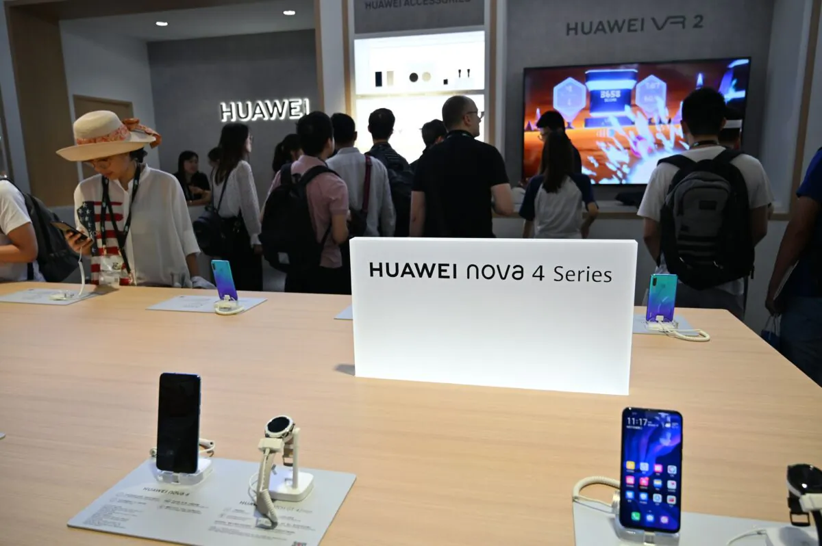 People look at the new Huawei smartphones at the company stand during the Consumer Electronics Show, Ces Asia 2019 in Shanghai on June 11, 2019. (HECTOR RETAMAL/AFP via Getty Images)