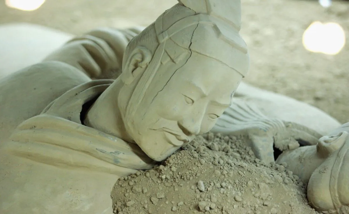 An imitation of a Qin Dynasty terracotta warrior lies in the Old Xian Museum in Xian, Shaanxi Province, China, on April 4, 2006. (China Photos/Getty Images)