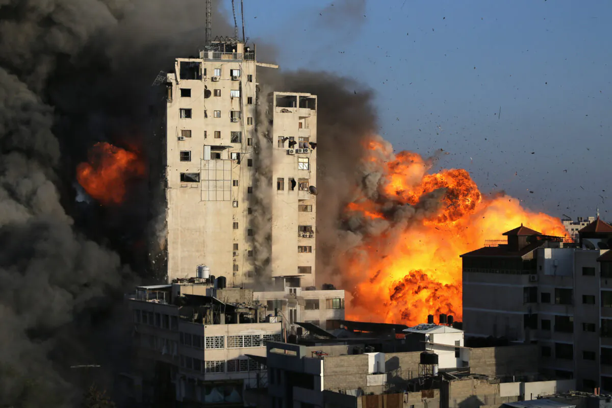 Smoke and flames rise from a tower building as it is destroyed by Israeli air strikes amid a flare-up of Israeli-Palestinian violence, in Gaza City on May 12, 2021. (Ibraheem Abu Mustafa/Reuters)