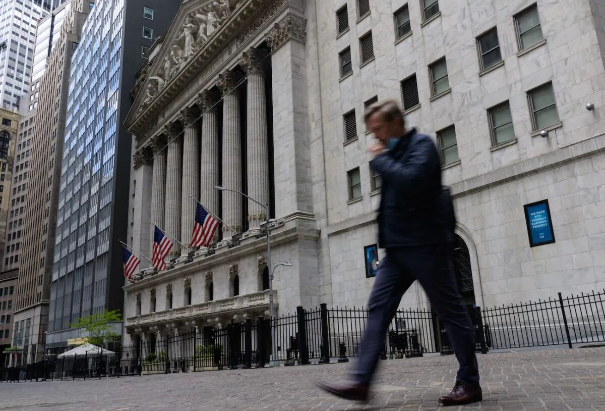 A man walks past the New York Stock Exchange on Wall Street in New York on May 10, 2021. (Angela Weiss/AFP via Getty Images)
