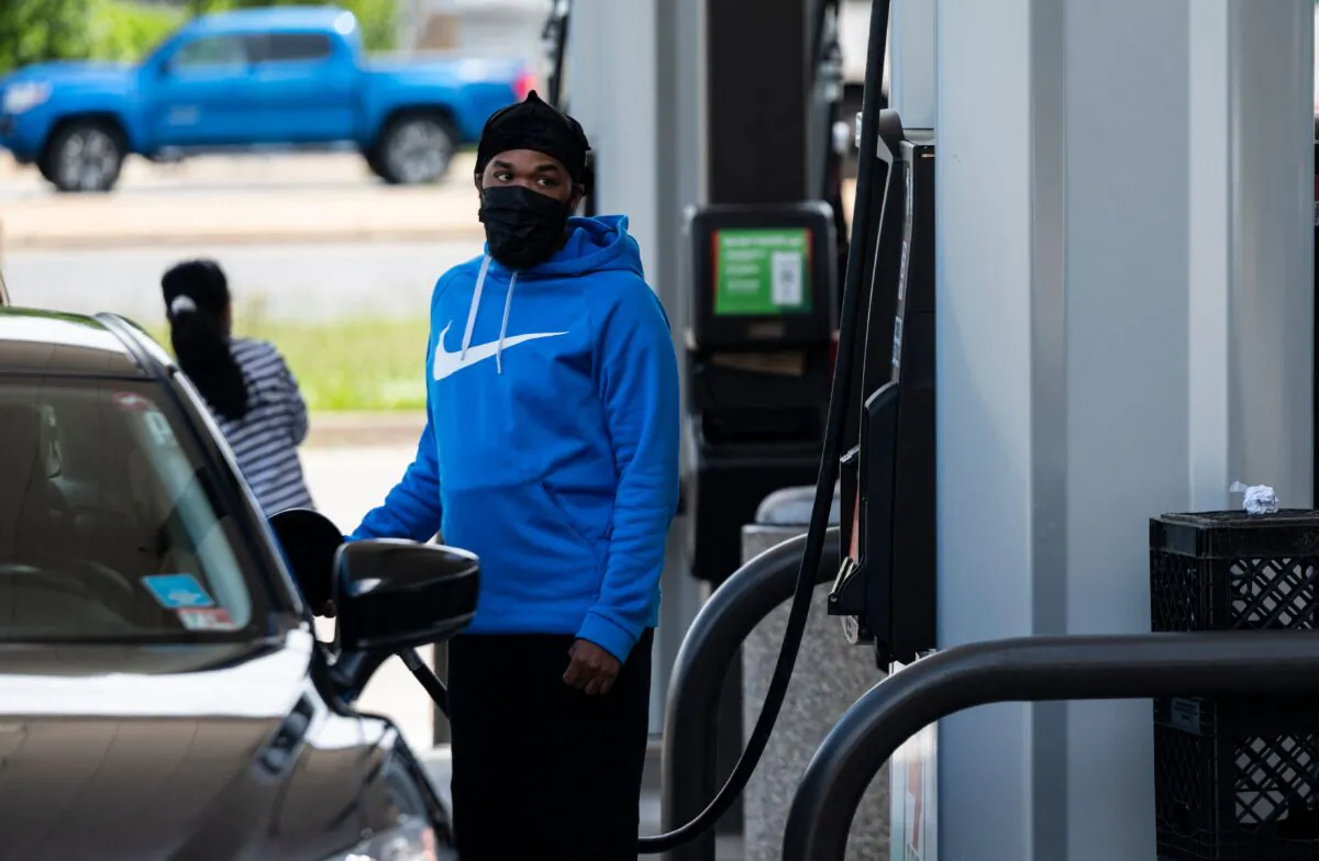 A motorist fills up at a gas station in Woodbridge, Va., on May 12, 2021. (Andrew Caballero-Reynolds/AFP via Getty Images)