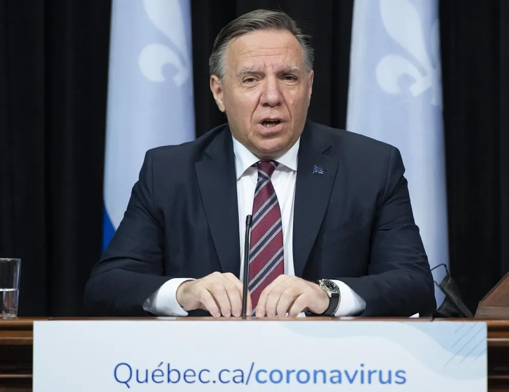 Quebec Premier Francois Legault, centre, speaks during a news conference on the COVID-19 pandemic, on May 11, 2021, at the legislature in Quebec City. (Jacques Boissinot/The Canadian Press)