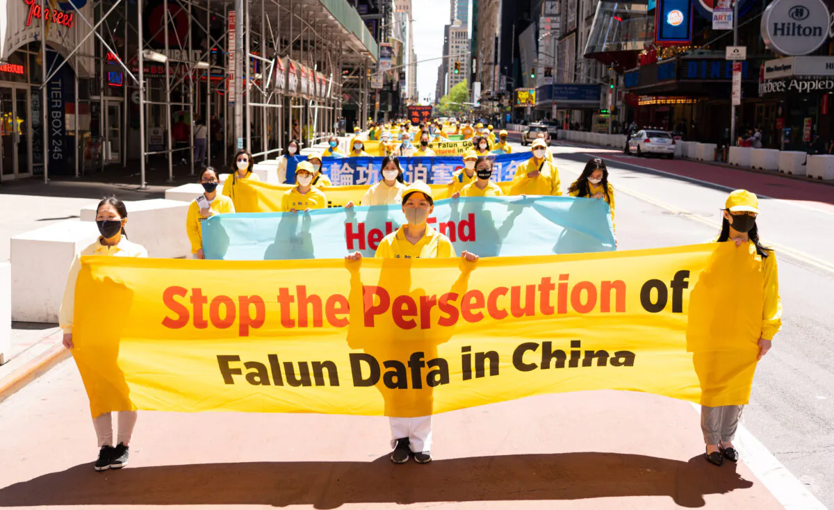 Practitioners of the spiritual discipline Falun Gong hold a parade in New York to celebrate World Falun Dafa Day and to protest the ongoing persecution of the spiritual practice by the Chinese Communist Party in China, on May 13, 2021. (Larry Dai/The Epoch Times)