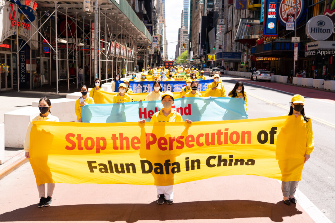 Practitioners of the spiritual discipline Falun Gong hold a parade in New York to celebrate World Falun Dafa Day and to protest the ongoing persecution of the group by the Chinese Communist Party in China, on May 13, 2020. (Larry Dai/The Epoch Times)