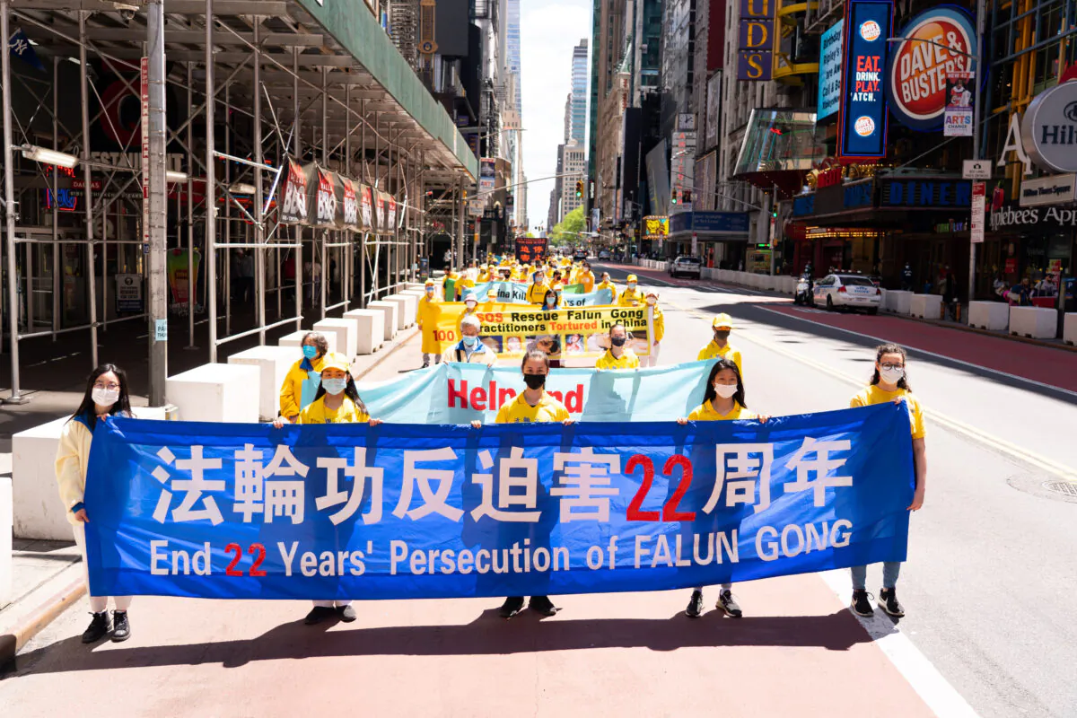 Practitioners of the spiritual discipline Falun Gong hold a parade to celebrate World Falun Dafa Day and to protest the ongoing persecution of the group by the Chinese Communist Party in China, in New York City, on May 13, 2021. (Larry Dai/The Epoch Times)