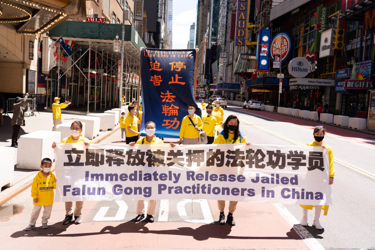 Practitioners of the spiritual discipline Falun Gong hold a parade in New York to celebrate World Falun Dafa Day and to protest the ongoing persecution of the group by the Chinese Communist Party in China, on May 13, 2020. (Larry Dai/The Epoch Times)