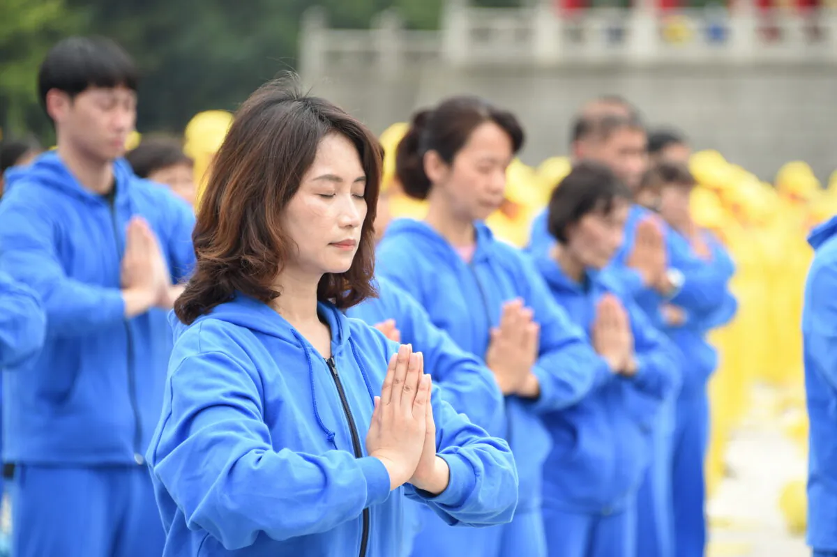Falun Gong adherents perform the exercises at an event celebrating World Falun Dafa Day in Taipei, Taiwan, on May 1, 2021. (Sun Hsiang-yi/The Epoch Times)