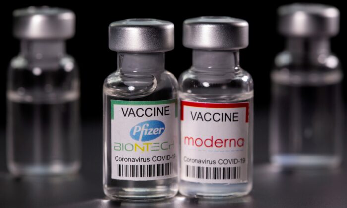 Vials with Pfizer-BioNTech and Moderna COVID-19 vaccine labels in an illustration picture taken on March 19, 2021. (Dado Ruvic/File Photo/Reuters)