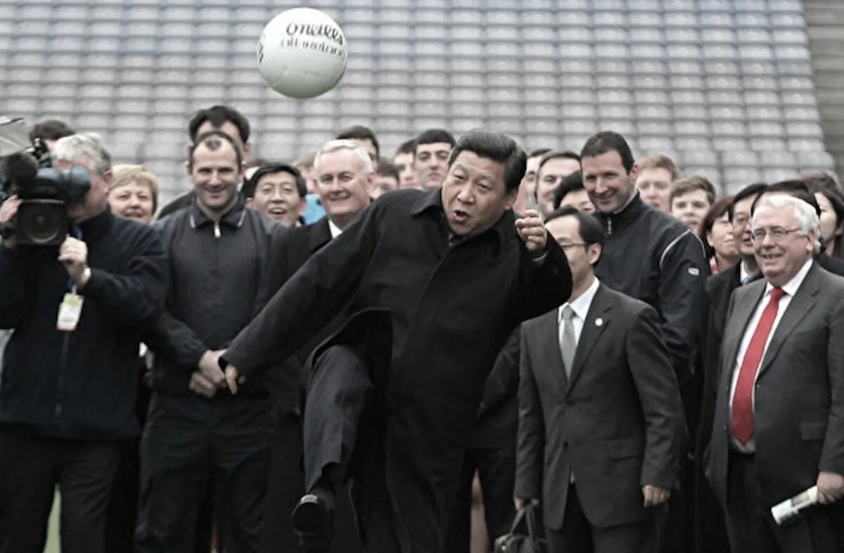 Then Chinese deputy leader Xi Jinping (C) kicks a Gaelic football as he visits at Croke Park in Dublin, Ireland on Feb. 19, 2012. (Peter Muhly/AFP/Getty Images)
