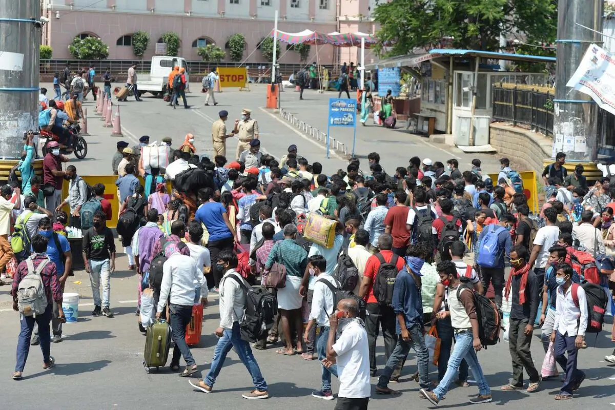 People wait in line outside a railway station to return home during the first day of a government imposed 10-day lockdown to curb the spread of COVID-19 in Secunderabad, India, on May 12, 2021. (Noah Seelam/AFP via Getty Images)