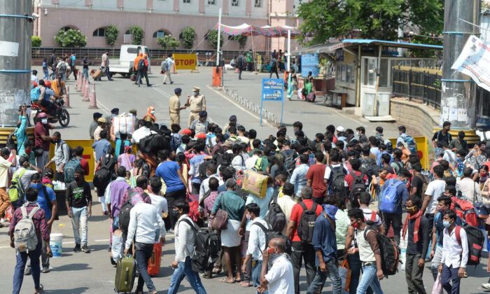 People wait in line outside a railway station to return home during the first day of a government imposed 10-day lockdown to curb the spread of COVID-19 in Secunderabad, India, on May 12, 2021. (Noah Seelam/AFP via Getty Images)