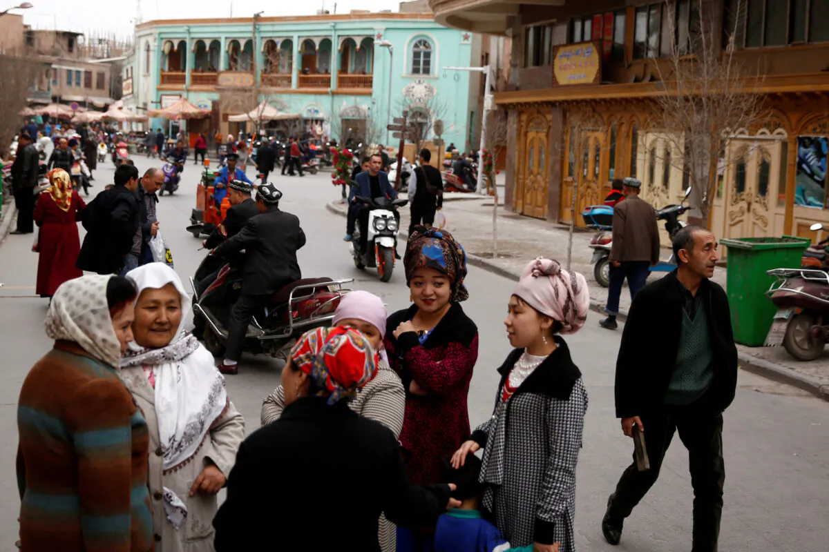 People mingle in the old town of Kashgar, Xinjiang Uighur Autonomous Region, China, on March 22, 2017. (Thomas Peter/File Photo/Reuters)