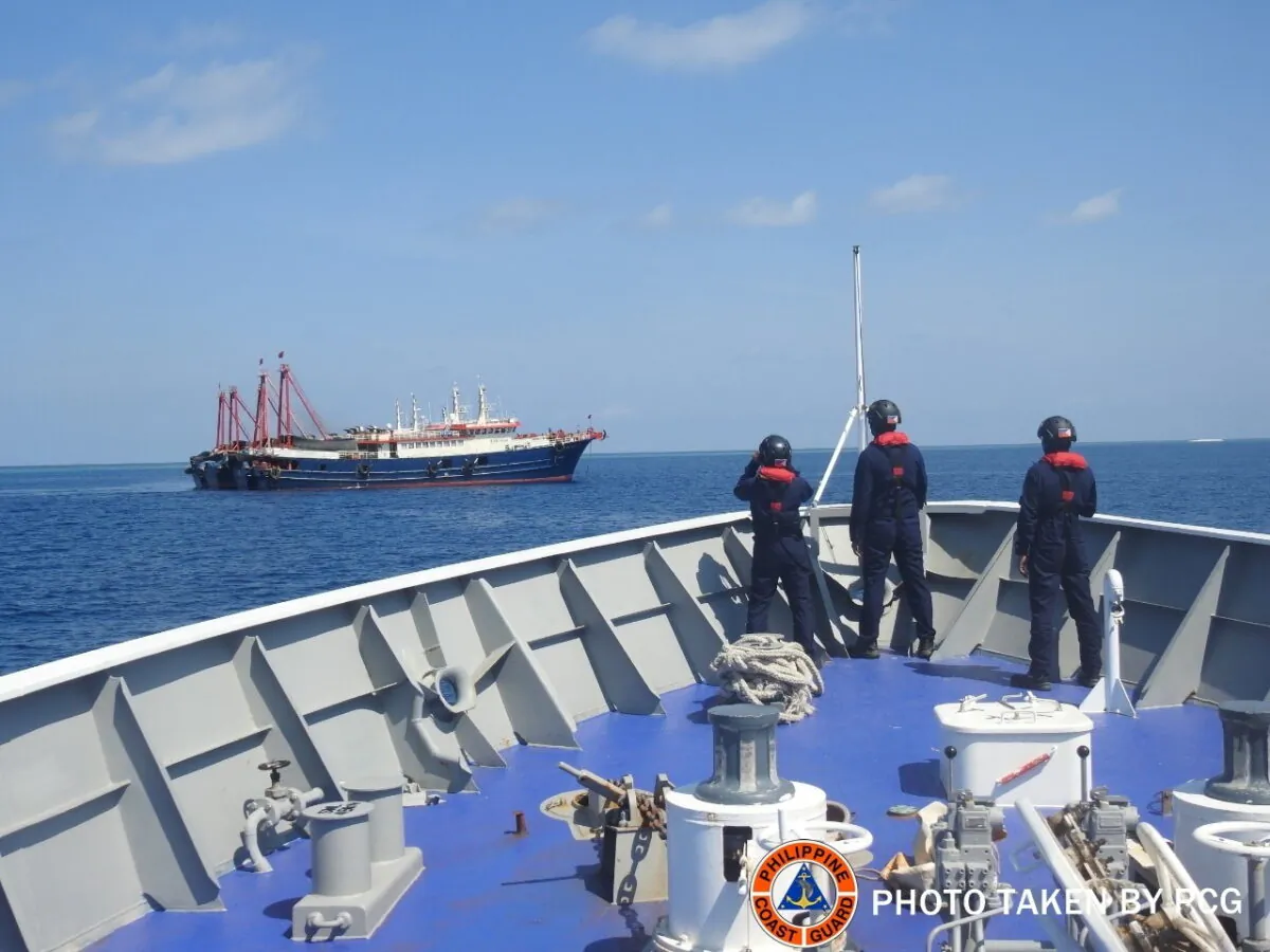 Philippine Coast Guard personnel survey several ships believed to be Chinese militia vessels in Sabina Shoal in the South China Sea, in a handout photo distributed by the Philippine Coast Guard on May 5 and taken according to source on April 27, 2021. (Philippine Coast Guard/File/Handout via Reuters)