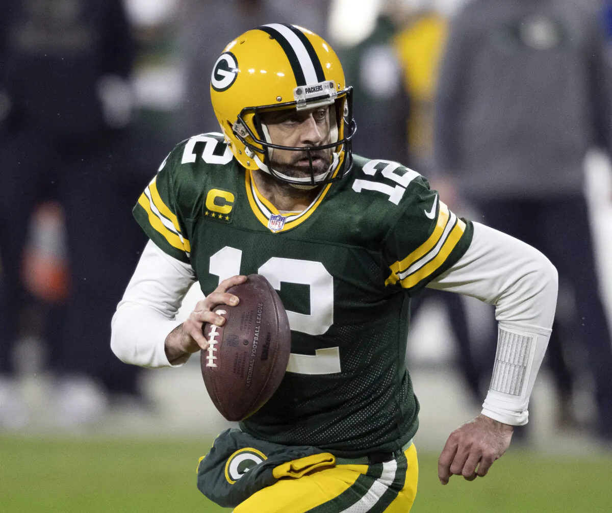 Green Bay Packers quarterback Aaron Rodgers (12) runs during an NFL divisional playoff football game against the Los Angeles Rams in Green Bay, Wis., on Jan. 16, 2021. (Jeffrey Phelps, File/AP Photo)