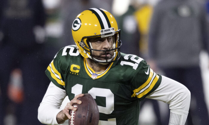 Green Bay Packers quarterback Aaron Rodgers (12) runs during an NFL divisional playoff football game against the Los Angeles Rams in Green Bay, Wis., on Jan. 16, 2021. (Jeffrey Phelps, File/AP Photo)