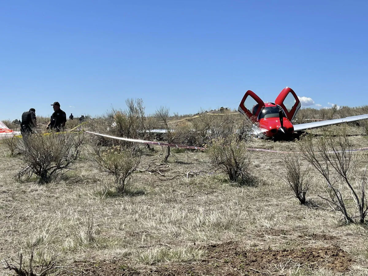 Officials at the scene of a plane crash where two small airplanes collide in midair near Denver, Colo., on May 12, 2021. (Arapahoe County Sheriff's Office)