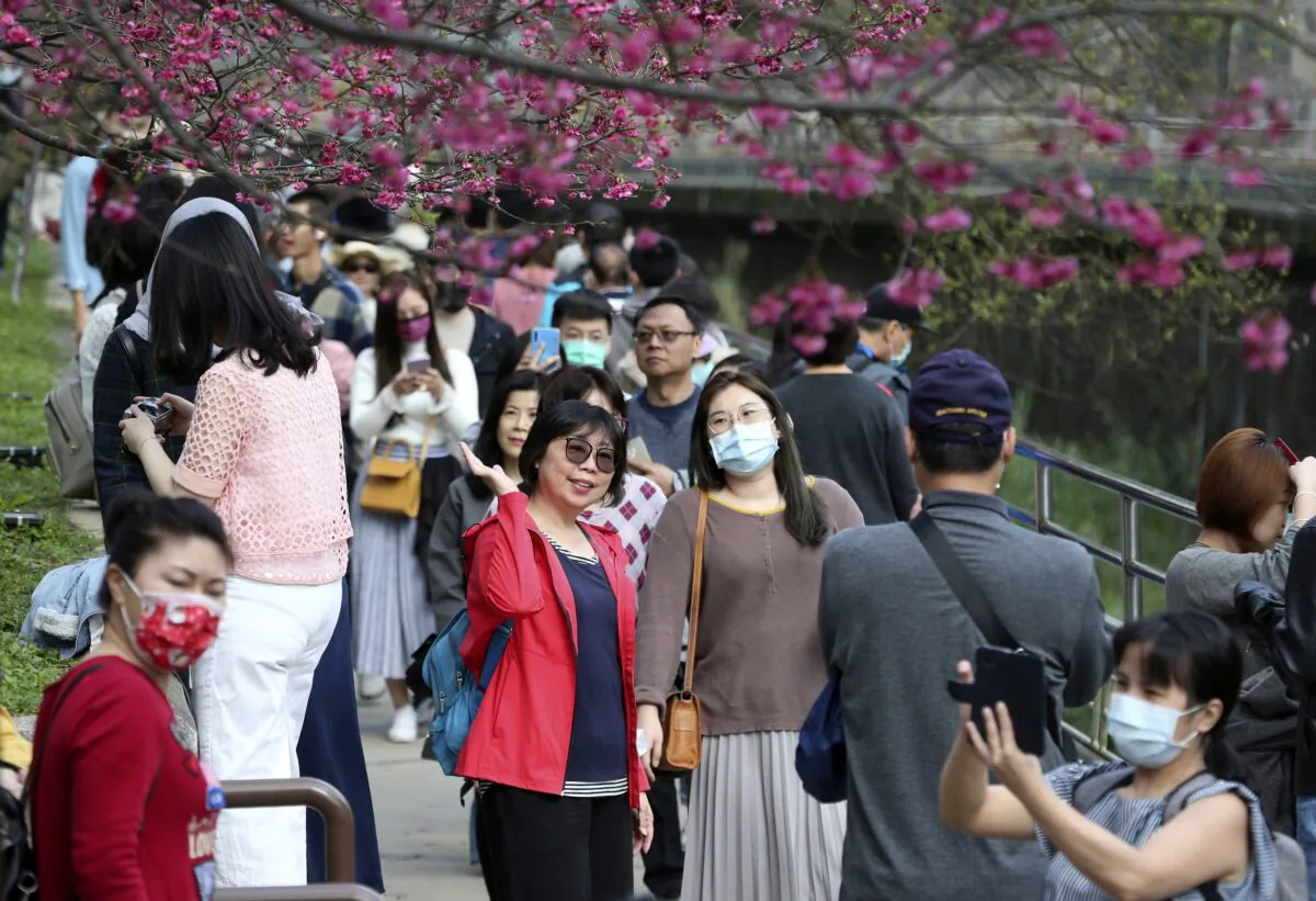 People enjoy the last day of the Chinese Lunar New Year celebrations in Taipei, Taiwan, on Feb. 16, 2021. (AP Photo/Chiang Ying-ying)